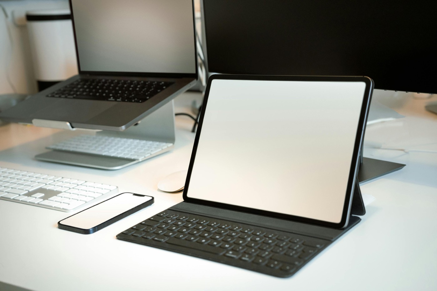 Laptops on a desk with a calendar and planning materials.